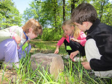 students examining a rock